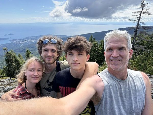 Mark Bailey with his sons Julian and Jack and Julian's partner Hj&ouml;rdes on the summit of Mount Elphinstone